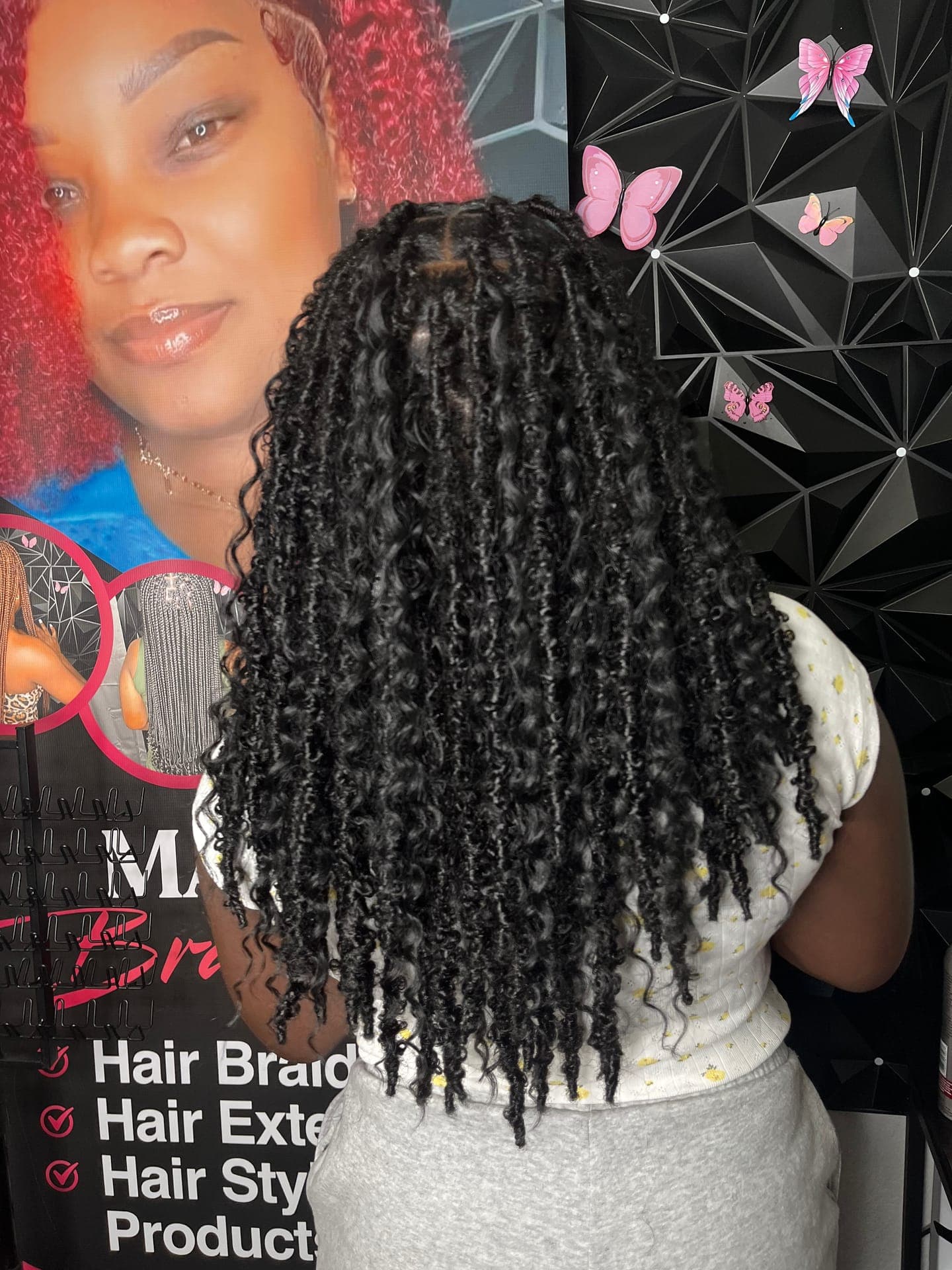 Box braids with curly ends, back view