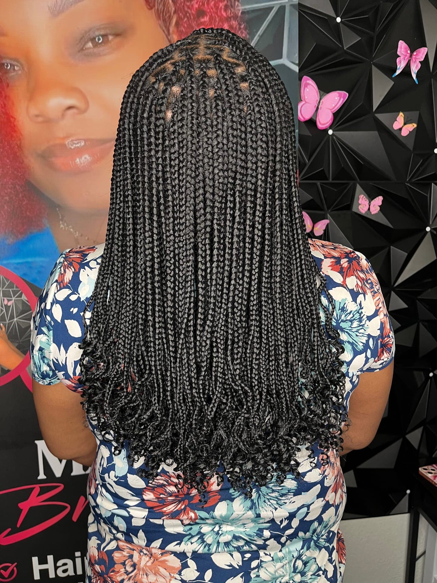 Box braids with curly ends, back view