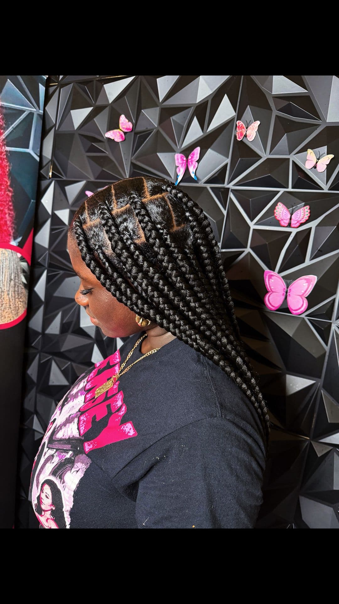 Side profile of sleek box braids with triangle parting