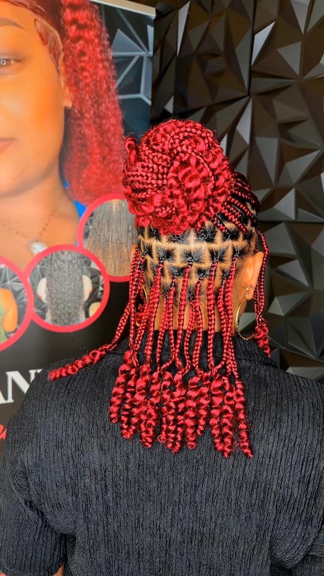 Red box braids styled into a bun updo