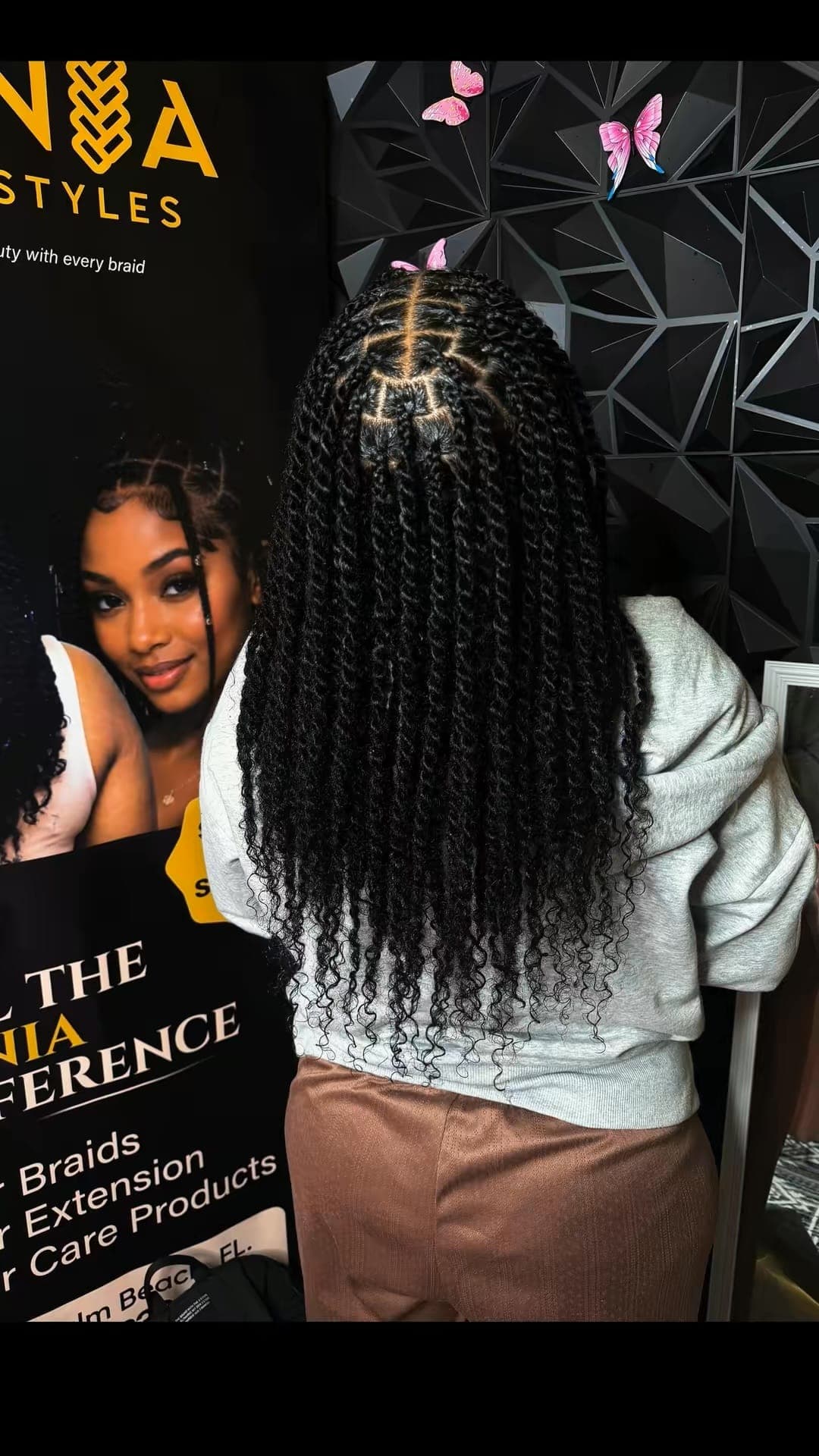 Back-of-head view of black senegalese twists with curly ends