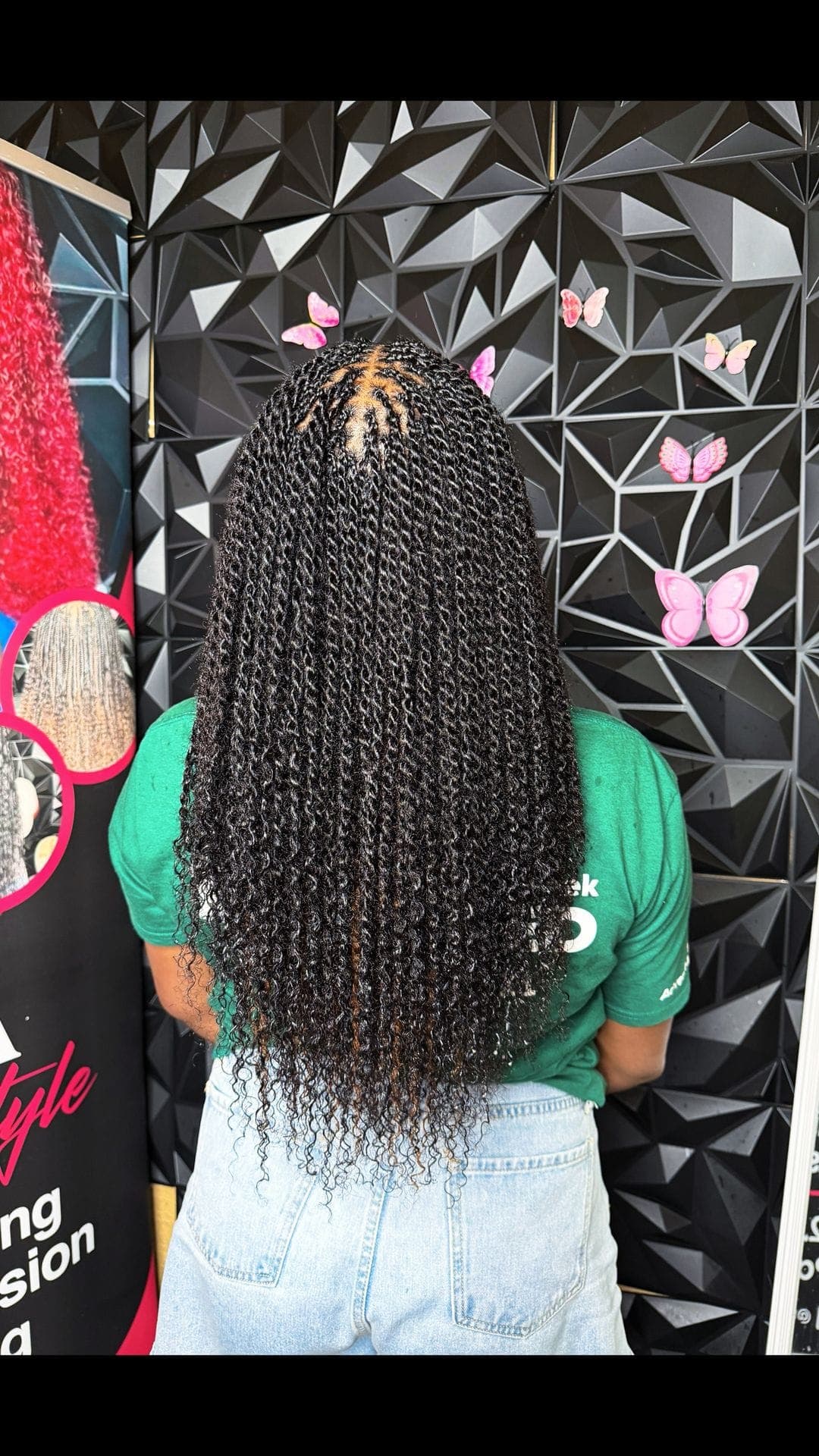 Back-of-head view of long black senegalese twists with curly ends
