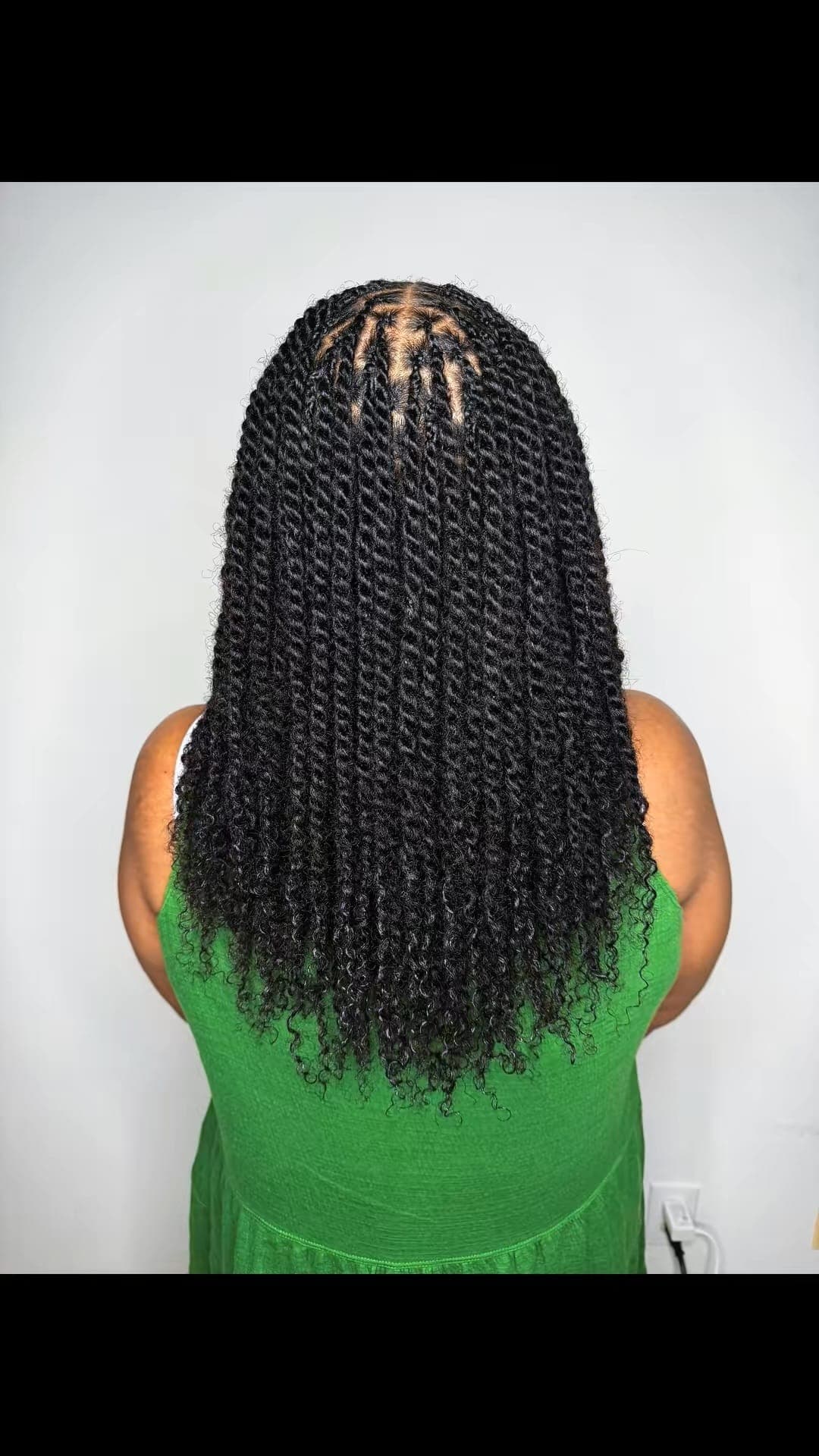 Back-of-head view of black senegalese twists with curly ends