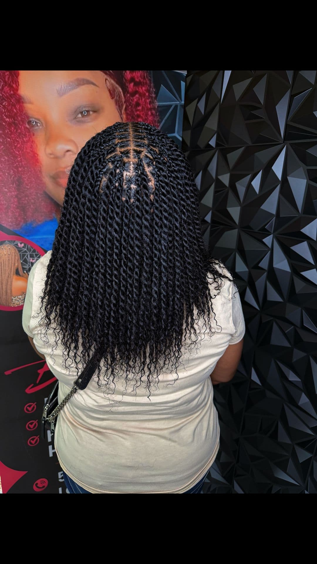 Back-of-head view of black senegalese twists with curly ends